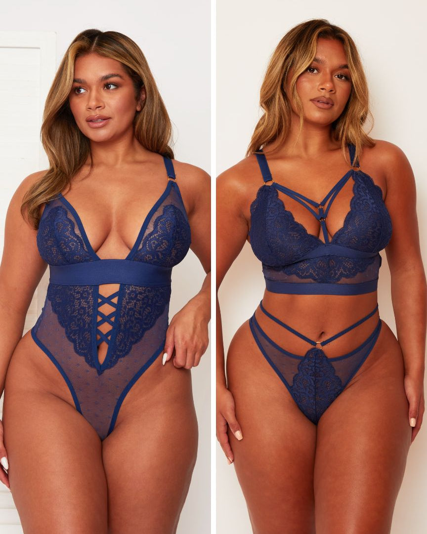 Woman wearing a blue lace lingerie set on a plain background