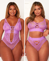 Woman wearing a purple lace lingerie set on a white background