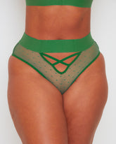 Close-up front view of the Abigail brief in Amazon Green, featuring sheer polka-dot mesh, a wide waistband, and decorative criss-cross strap detailing at the front for a flattering, contemporary look.