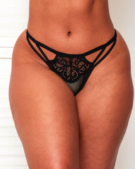 Front view of Tutti Rouge Artemis black thong with strappy cut-out sides, floral lace and sheer mesh.