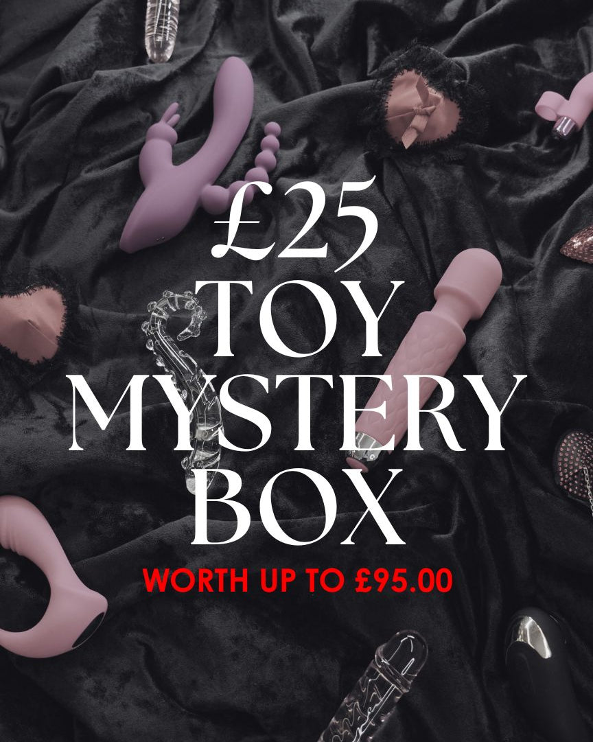 Toy mystery box promotion with various toys on a dark fabric background