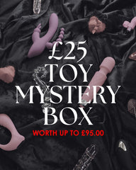 Toy mystery box promotion with various toys on a dark fabric background