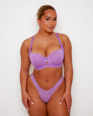 Model wearing Tutti Rouge Daley Lace underwired T-shirt bra in Amethyst Orchid with a matching purple floral lace thong.