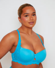 Close-up of Tutti Rouge Daley Lace bra in Bluebird Blue on a model, showing smooth moulded cups, scalloped lace and centre cut-out.