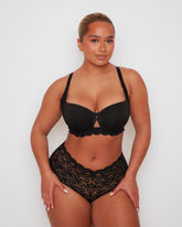 Model wearing Tutti Rouge Daley bra in Midnight Black with smooth moulded cups and scalloped lace trim, paired with lace briefs.