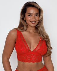 Fuller bust model wearing the Eva lingerie set in chilli red, featuring soft stretch lace, dotted mesh panels and a supportive wireless bralette.