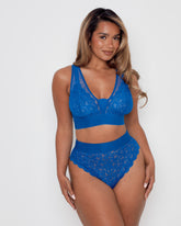 Model wearing the Hallie Bra and Brief Set in Dazzling Blue by Tutti Rouge, featuring soft floral lace, sheer mesh panels, a deep V-neckline, and high-waisted briefs for a flattering everyday fit.