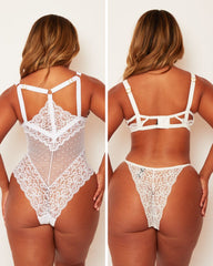 White lace lingerie set worn by a model on a plain background