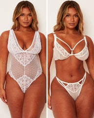 White lace lingerie set on a model against a white background