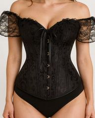 Black lace corset worn by a model on a plain background
