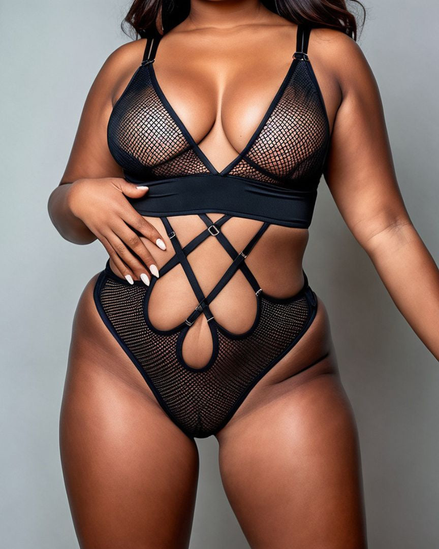 A model wearing a black fishnet bodysuit with a crisscross strappy design and gold accent hardware.