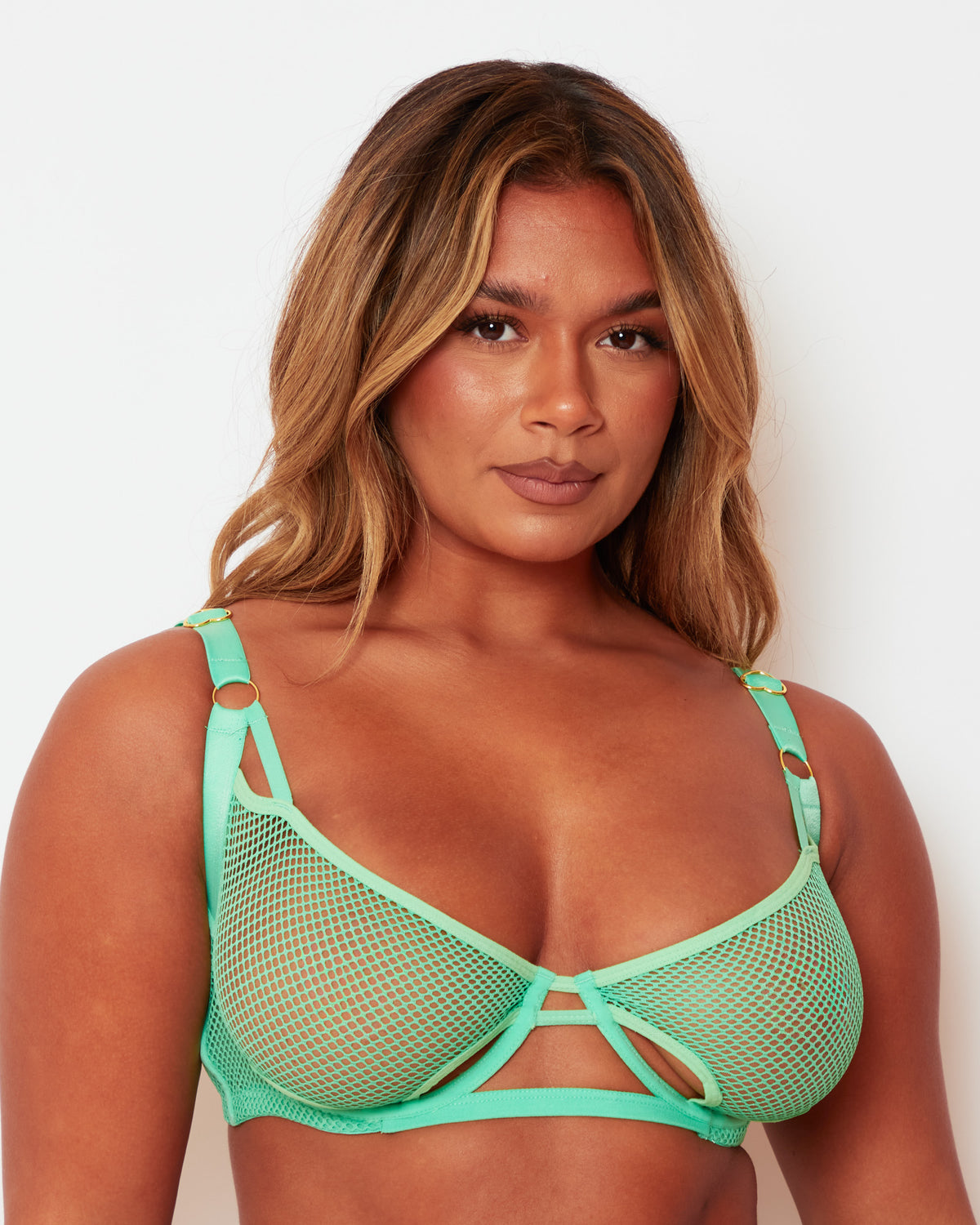 Close-up of the Tutti Rouge Aphrodite Apple Green fishnet bra, showing cut-out cups and gold-tone strap rings.