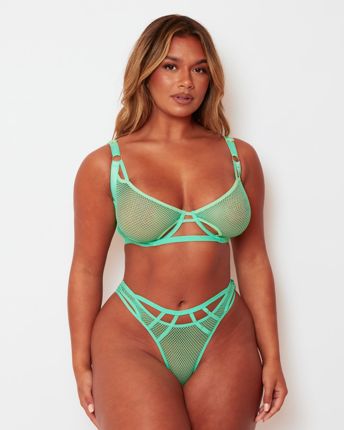 Front view of the Tutti Rouge Aphrodite Apple Green fishnet bra and thong set with cut-out detailing and gold-tone hardware.