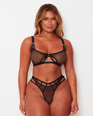 Front view of a model wearing the Tutti Rouge Aphrodite black fishnet lingerie set with a cut-out bra and matching thong.