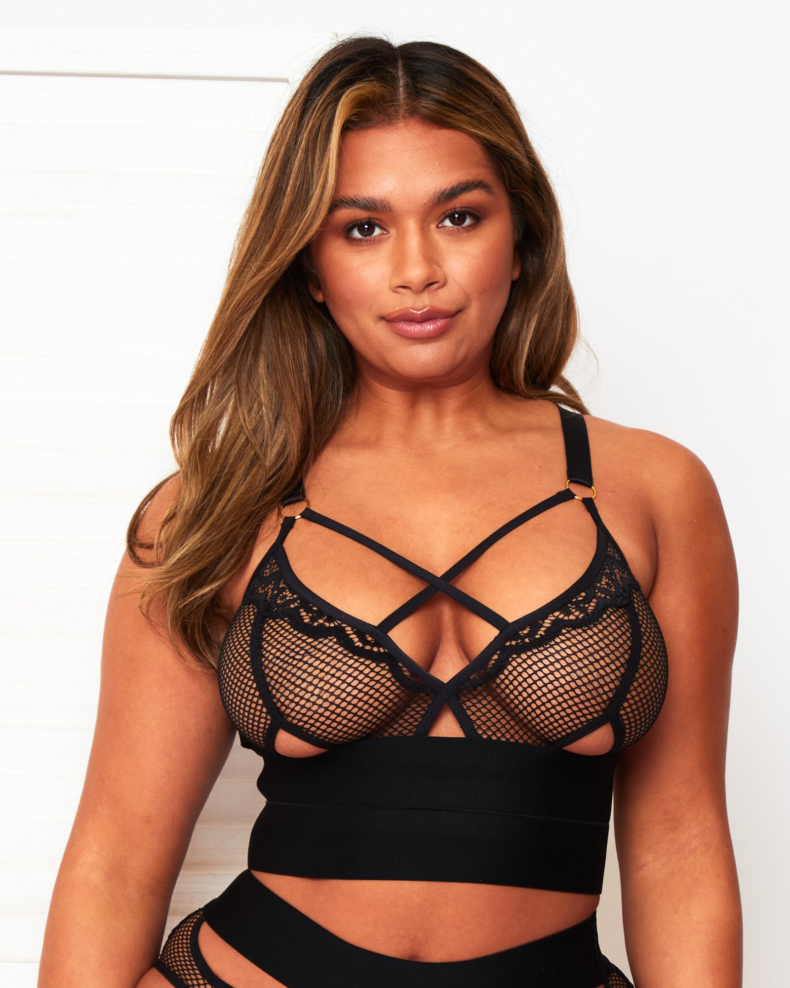 Front view of the Tutti Rouge Athena black longline bralette with fishnet cups, crossover straps and a wide double underband.