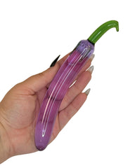 Brand X toys Aubergine Queen curved glass dildos and adult novelties showcased in hand.