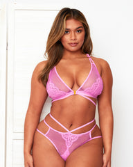 Model wearing the Tutti Rouge Aura Violet plunge bralette and matching fishnet briefs with floral lace and slim waist straps.