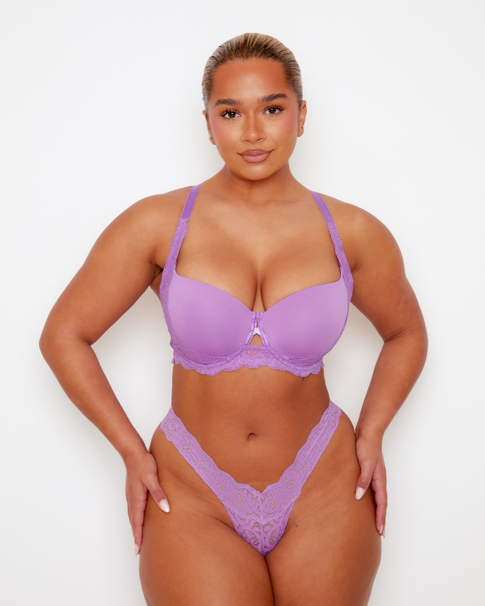 Front view of Tutti Rouge Daley Lace bra in Amethyst Orchid, with moulded cups and scalloped lace underband, worn with a purple lace thong.