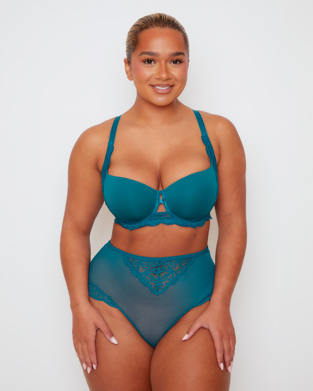 Model wearing Tutti Rouge Daley lace bra and Bellatrix high waist briefs in Blue Coral, shown from the front.
