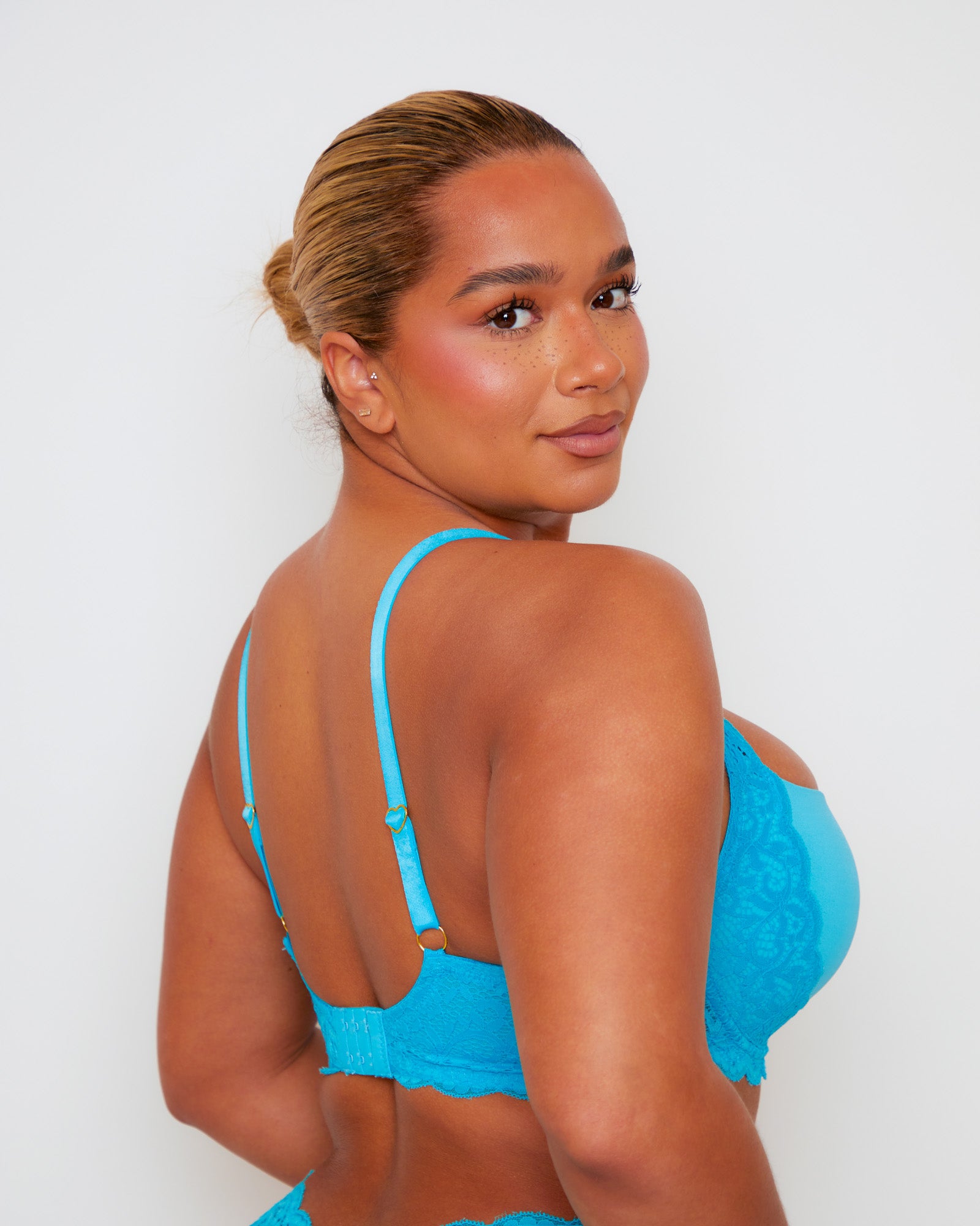 Angled rear close-up of Tutti Rouge Daley Lace bra in Bluebird Blue, showing lace back, hook-and-eye fastening and heart strap sliders.