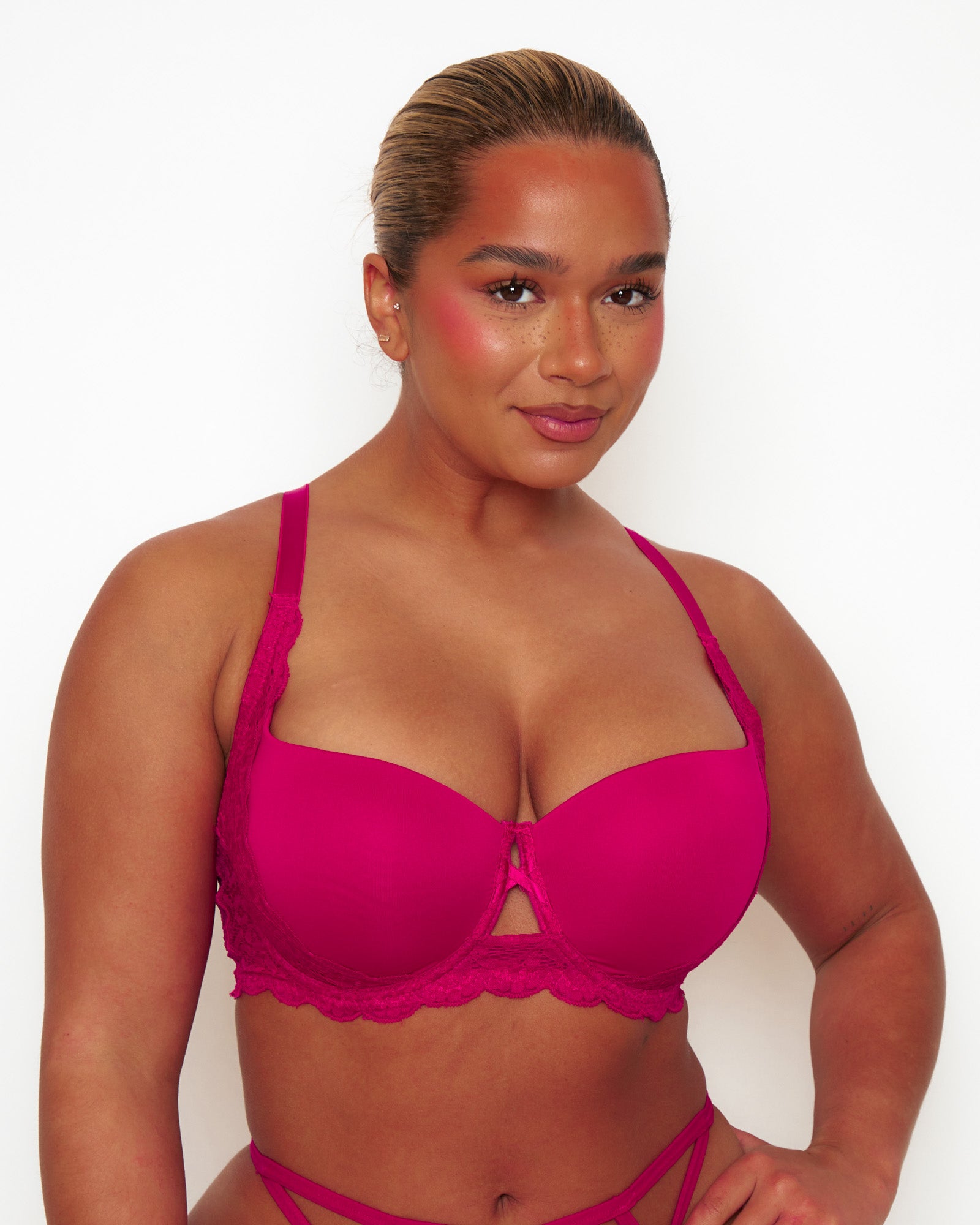Close-up of Tutti Rouge Daley Lace bra in Cherry on a model, showing smooth moulded cups, scalloped lace underband and centre cut-out.