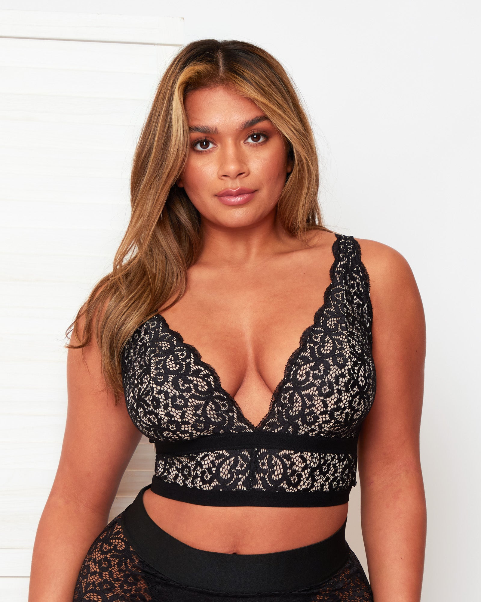 Front close-up of the Tutti Rouge Eden Midnight Black bralette, featuring black floral lace over a light lining and scalloped edges.