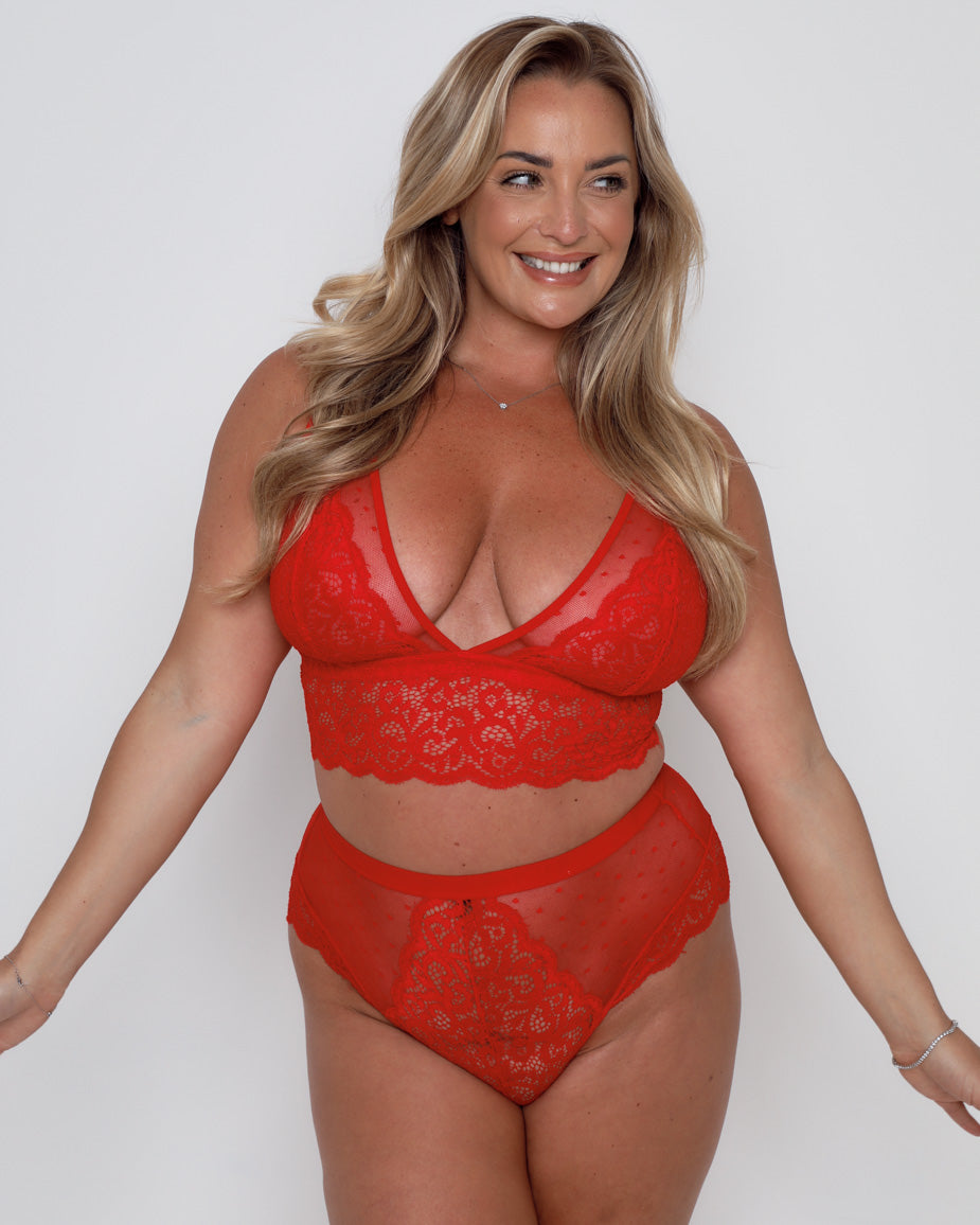 Fuller bust model wearing the Eva Bralette and Brief Set in chilli red, designed to flatter curves with soft lace and comfortable support.