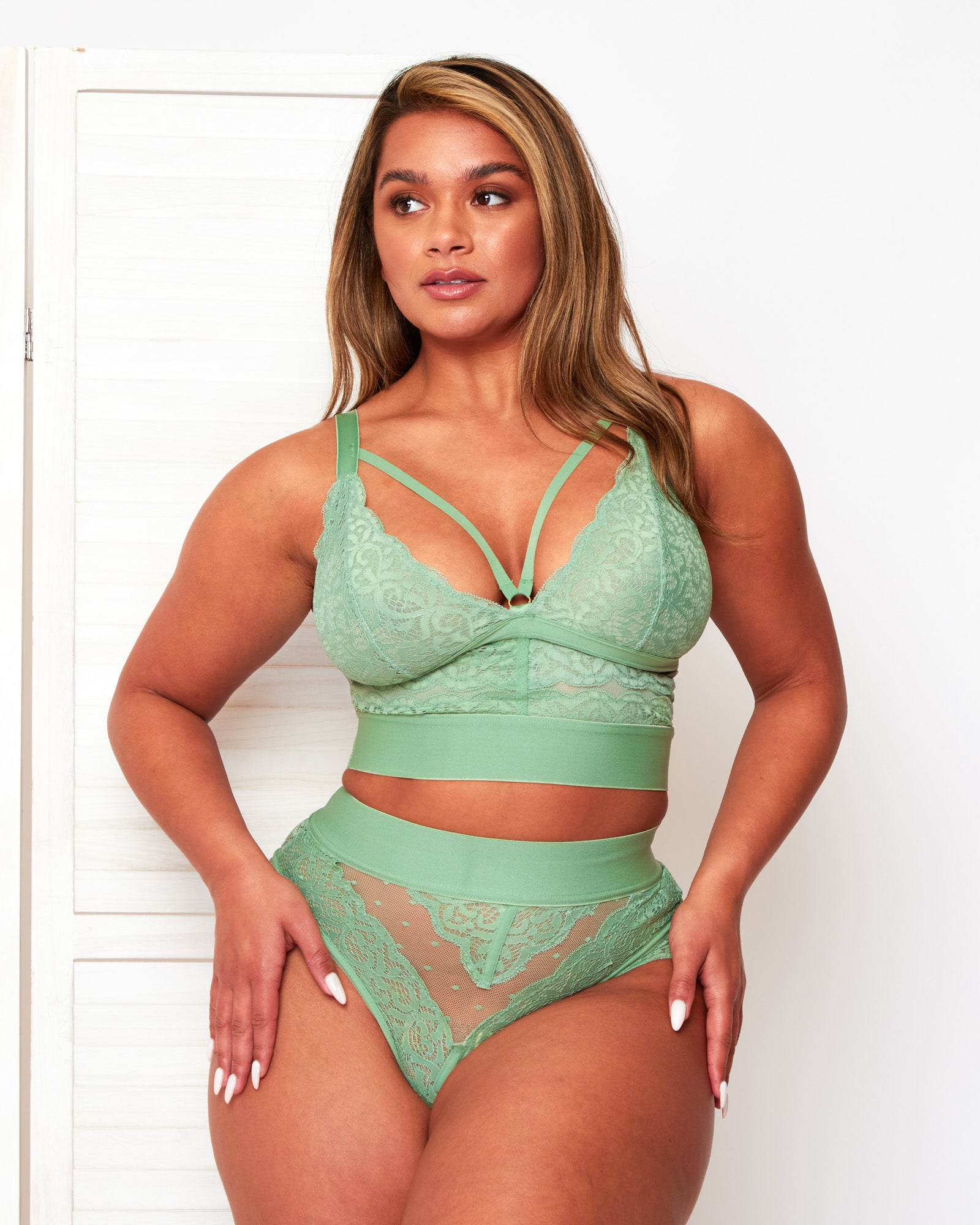 Front view of the Tutti Rouge Gia Basil Green lingerie set, showing scalloped lace cups, a central gold-tone ring and dotted mesh thong.