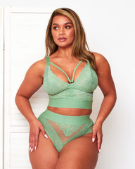 Front view of the Tutti Rouge Gia Basil Green lingerie set, showing scalloped lace cups, a central gold-tone ring and dotted mesh thong.