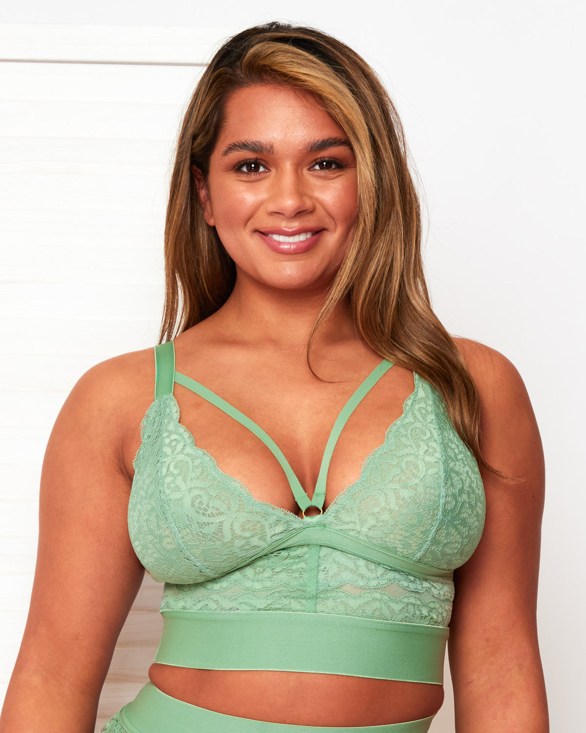 Front close-up of the Tutti Rouge Gia Basil Green bralette with scalloped floral lace cups, a strappy plunge neckline and deep underband.