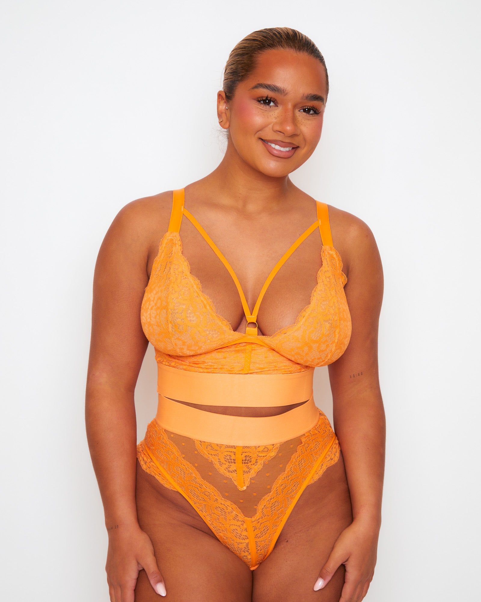 Front view of the Tutti Rouge Gia Sunburst Orange bralette and thong set with a strappy plunge neckline and wide bands.
