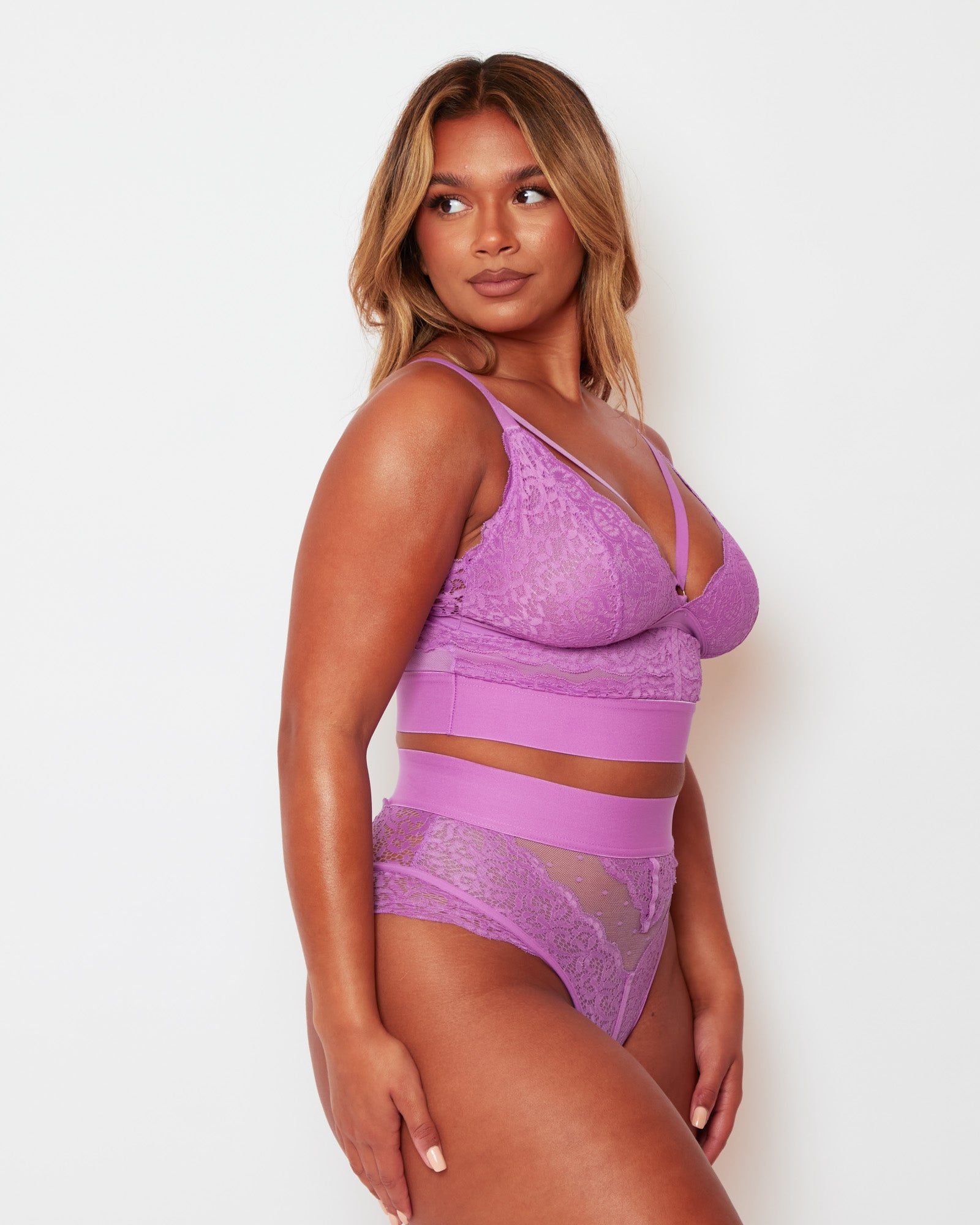 Side view of the Tutti Rouge Gia Pillow Purple bralette and thong set, showing floral lace panels and wide underband.