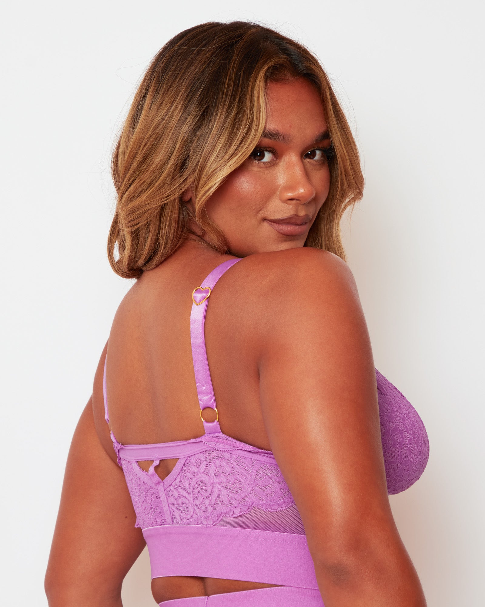 Angled back close-up of the Tutti Rouge Gia Pillow Purple bralette, showing floral lace, sheer mesh and a gold-tone heart strap slider.