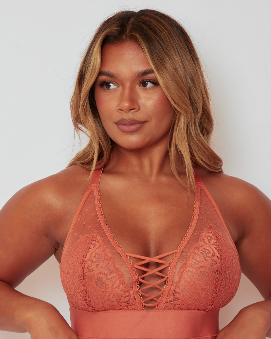 Front view of the Maya Bralette in Cider Orange, showcasing delicate floral lace, sheer dotted mesh, and elegant lace-up detailing that creates a flattering, feminine silhouette.