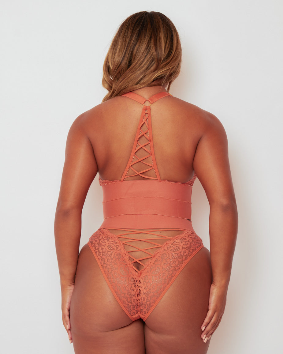 Rear view of the Maya Bralette & Brief Set in Cider Orange, highlighting the racerback lace-up detail, flattering Brazilian-style brief, and delicate floral lace for an eye-catching finish.