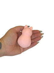 Hand holding a pink silicone product on a white background