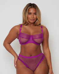 Model wearing the Tutti Rouge Raya Sheer Balcony Bra and matching briefs in Vamp Purple, fuller bust lingerie set with supportive DD+ balcony bra.