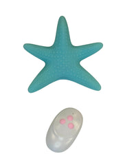 Turquoise starfish-shaped object with a remote control on a white background