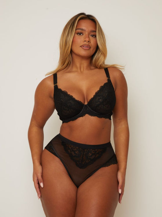 full length image of woman wearing a Tutti Rouge lace plunge bra and matching brazilian in midnight black
