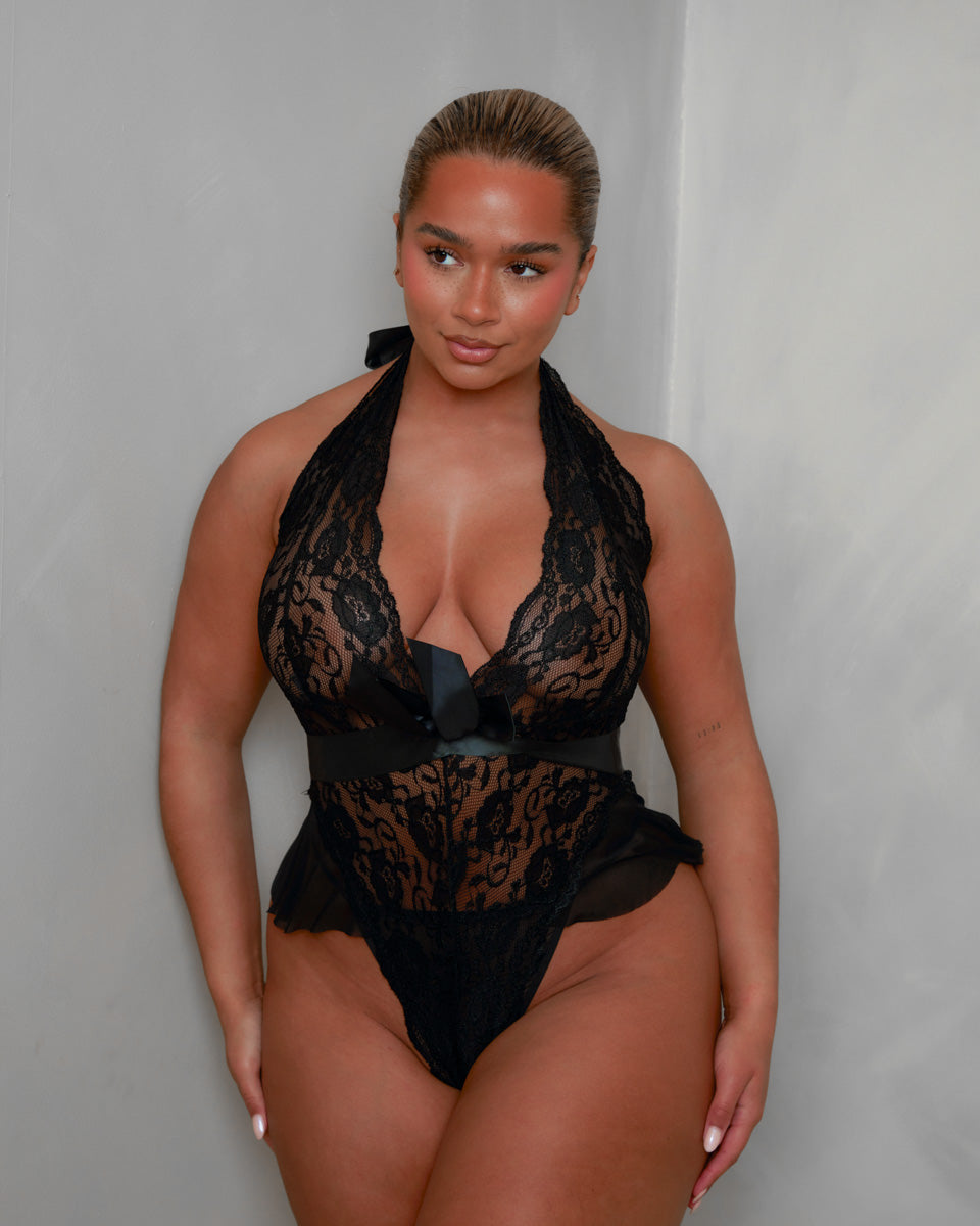 Front view of the Tutti Boudoir Imani Teddy in Onyx Black, highlighting the sheer floral lace body, halterneck styling and flattering high-leg cut with soft mesh frill detailing.