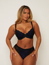 full length image of girl wearing a black and blue lace plunge bra and matching brazilian