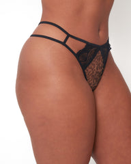 Side view of Tutti Rouge Shania Thong in Wild Leopard on a model, showing strappy sides, black lace and leopard print front panel.